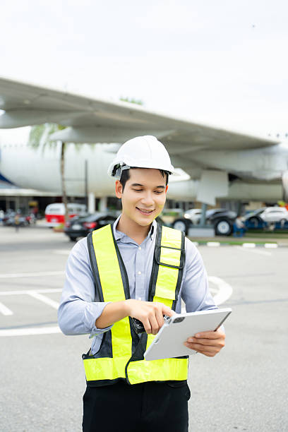 istock Aviation engineer inspects airplane for safety compliance. Professional aerospace technician at work in airport maintenance 2240699416