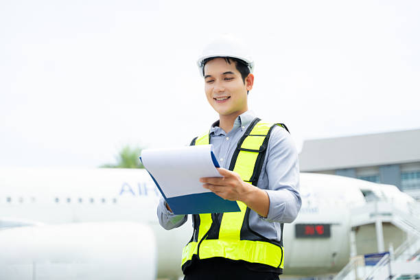 istock Aviation engineer inspects airplane for safety compliance. Professional aerospace technician at work in airport maintenance 2240699417