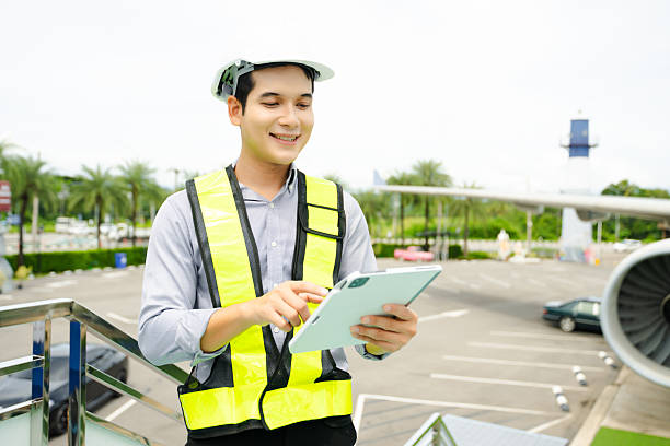 istock Aviation engineer inspects airplane for safety compliance. Professional aerospace technician at work in airport maintenance 2240699419