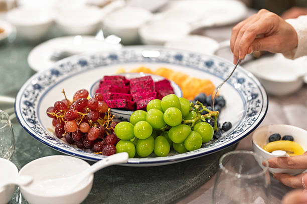 Assorted sliced fruits served on a plate at restaurant table