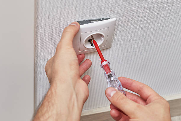 istock male hands installing electrical wall outlets with a screwdriver 2240701372