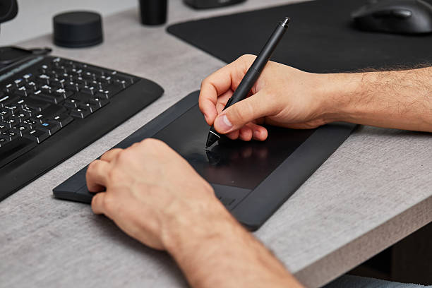 istock male hands retouching image on pc using graphic tablet and stylus pen 2240701468