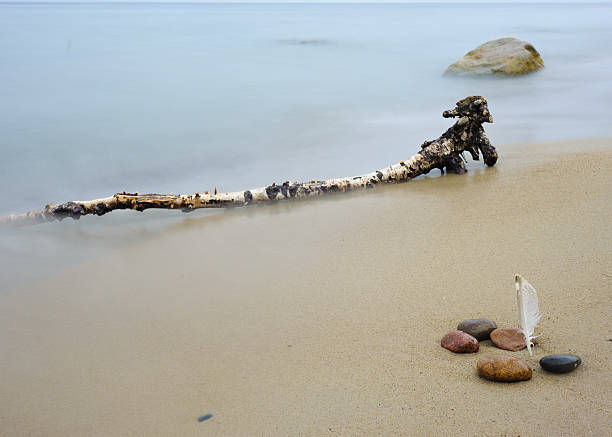 Lonely cross in the fog in a pile of wet stones