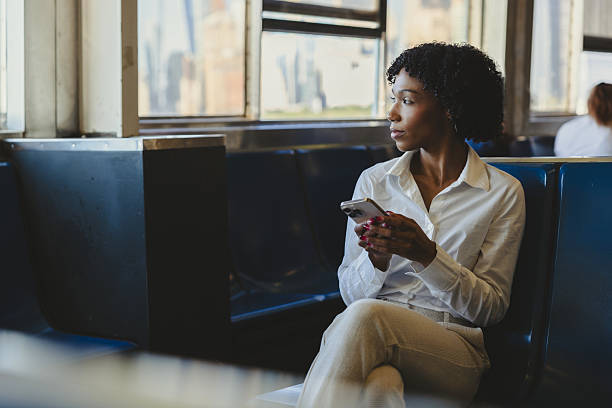 istock Woman sitting on public transit during early morning commute 2240703546