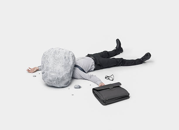 istock A Businessman Lying on the Ground Covered by a Huge Boulder While Holding a Briefcase 2240703626