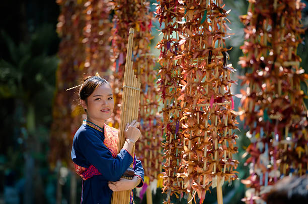 girl in folk costume with folk music called Kaen or can In Wat Wang Kham, Kalasin Province, Thailand
