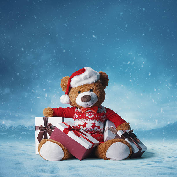 istock Cute teddy bear with gifts under the snow 2240706606