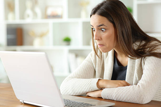 istock Perplexed woman checking laptop content in a house 2240708749