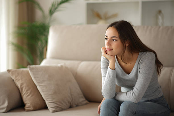 istock Relaxed woman thinking and looking away at home 2240708752