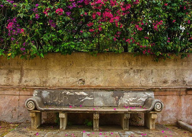 A Vibrant Floral Landscape in a Garden with Layers of Colorful Bushes and Flowers Under a Cloudy Sky