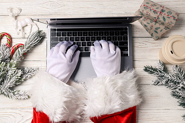 istock New year concept, Santa's hand with laptop 2240711939