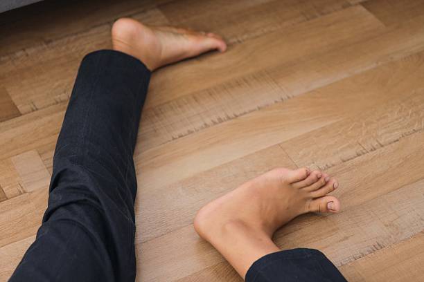 istock Close Up Of Man Legs Lying On The Floor, Falling from Unexpected Accident 2240712023