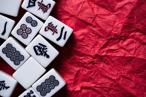 istock Mahjong tiles lined up on a red background 2240712081