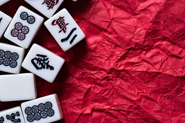 istock Mahjong tiles lined up on a red background 2240712084