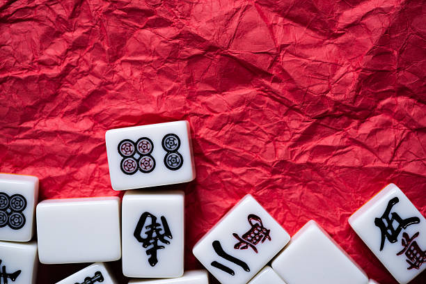 istock Mahjong tiles lined up on a red background 2240712095