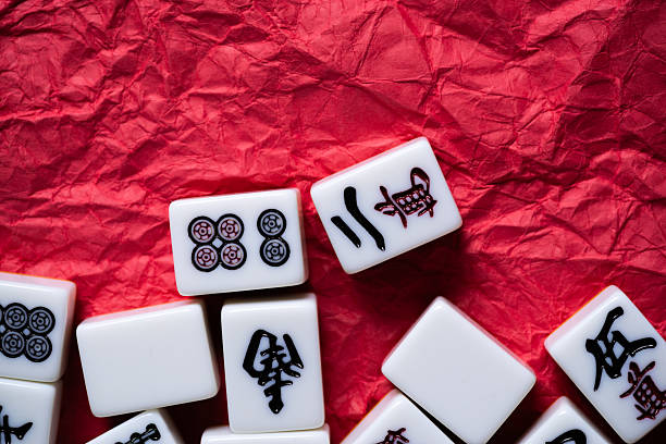 istock Mahjong tiles lined up on a red background 2240712116