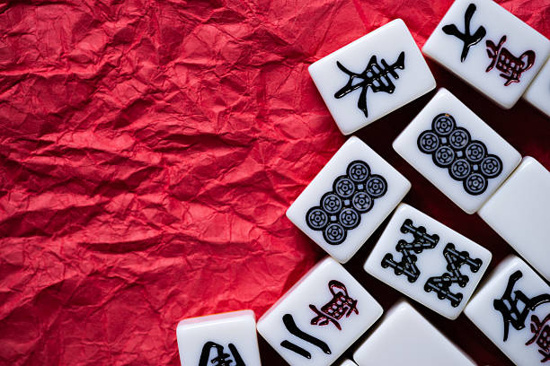 istock Mahjong tiles lined up on a red background 2240712123