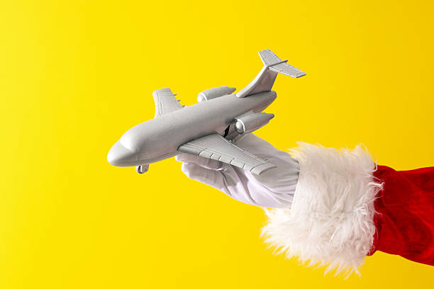 istock New Year concept, Santa's hand with a toy airplane 2240712176