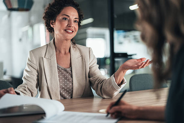 istock Professional discussion between advisor and client and successful signing of contract 2240713260