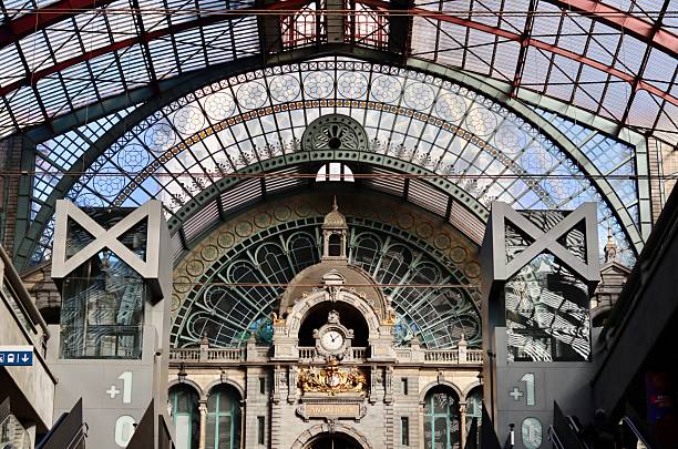 istock Antwerp Central Station ornate architecture with glass roof, clock tower, and modern elevator, travel destination in Belgium 2240713652