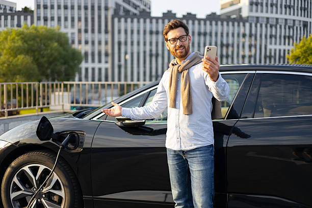 istock Man Charging Electric Vehicle 2240716110
