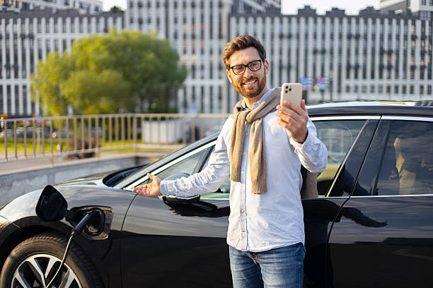 istock Man Charging Electric Vehicle 2240716115