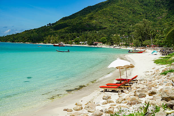 istock Relaxing beach scene with beach umbrella shading comfortable beds , cabana, water, sunshade. Beautiful beach and white sand with beach chair. Asian tropical beach paradise in Thailand 2240716285