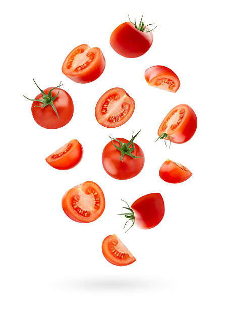 istock Ripe cherry tomatoes with green stem, whole, quarter, piece fall on white background as art composition, isolated. Summer healthy eating and organic food for advertising, design, branding product. 2240717566