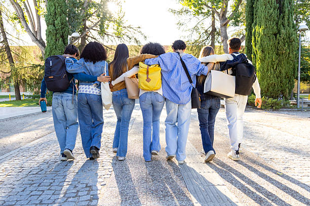 istock Diverse students walking together on university campus outdoor 2240724035