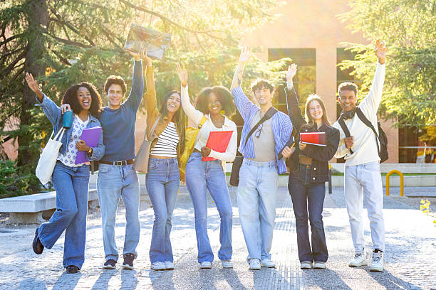 istock Diverse students celebrating success on university campus 2240724040