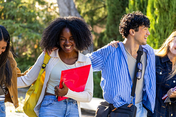 istock Diverse students walking together, laughing on campus 2240724047