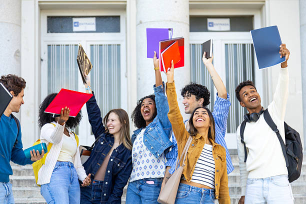 istock Happy diverse university students celebrating graduation day success 2240724086