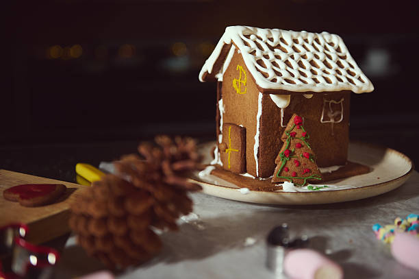 istock Gingerbread House With Icing Roof And Festive Christmas Tree On Plate 2240724507
