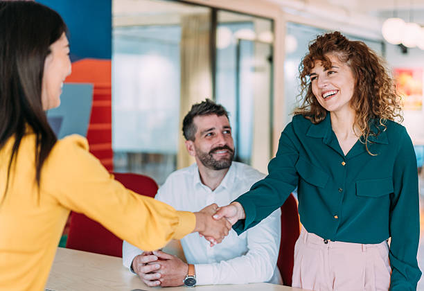 istock Businesspeople shaking hands across the table. 2240724974