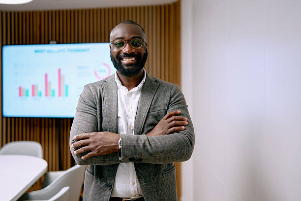 istock Confident businessman standing in modern office meeting room 2240725106