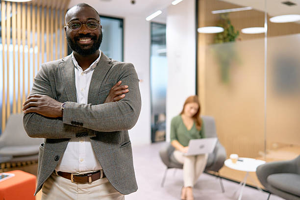 istock Confident businessman smiling in modern corporate office 2240725317