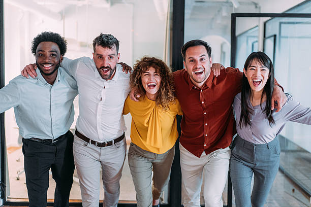 istock Excited coworkers embracing each other during a celebration in the office. 2240725650