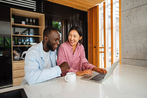 istock Multicultural couple working remotely, planning finances and investments. Digital nomad lifestyle 2240726934