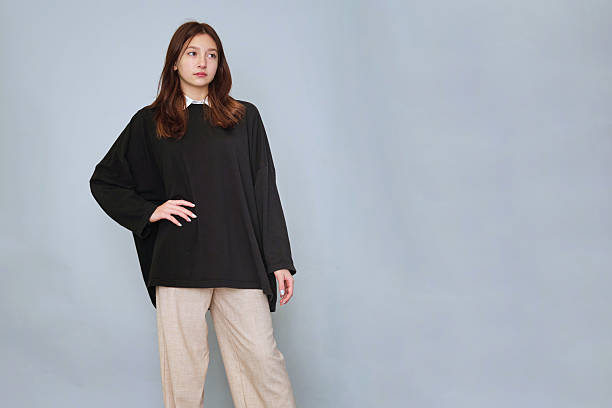 istock Serious Young Model in Black Hoodie: Featuring a serious and deep-thinking 15-year-old in a black hoodie. branding, with ample space for logos or messages, suitable for urban fashion promotions 2240727250