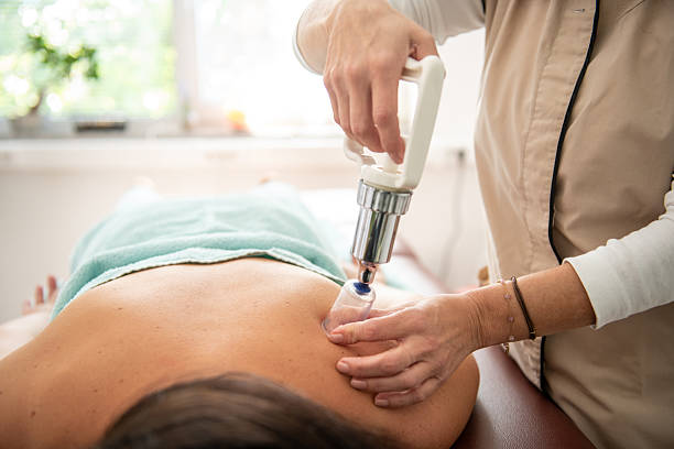 Examination by a physiotherapist doctor for manual therapy: massage, examination, cupping therapy, relaxation in a naturopathic studio.