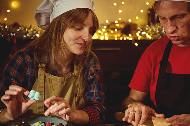 istock Warm Christmas Baking Scene With Couple Chefs Preparing Candies In Cozy Kitchen 2240727996