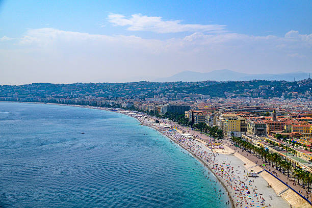 View on Nice over the Promenade des Anglais along the Mediterranean coast from Castle Hill (Colline du Château), France during a summer day. Located on the French Riviera, the southeastern coast of France on the Mediterranean Sea, at the foot of the French Alps, Nice is the second-largest French city on the Mediterranean coast and second-largest city in the Provence-Alpes-Côte d'Azur region