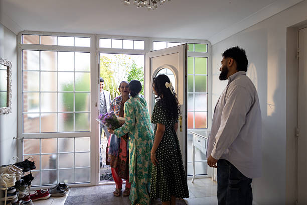 istock Family Welcoming Guests at Front Door 2240728601
