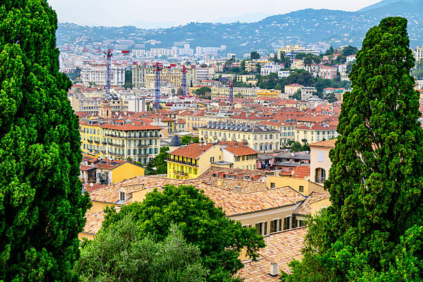 View on Nice from Castle Hil (Colline du Château), France during a summer day. Located on the French Riviera, the southeastern coast of France on the Mediterranean Sea, at the foot of the French Alps, Nice is the second-largest French city on the Mediterranean coast and second-largest city in the Provence-Alpes-Côte d'Azur region