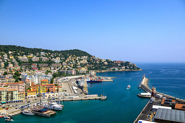 View on Nice over the Port of Nice from Castle Hill (Colline du Château), France during a summer day. Located on the French Riviera, the southeastern coast of France on the Mediterranean Sea, at the foot of the French Alps, Nice is the second-largest French city on the Mediterranean coast and second-largest city in the Provence-Alpes-Côte d'Azur region