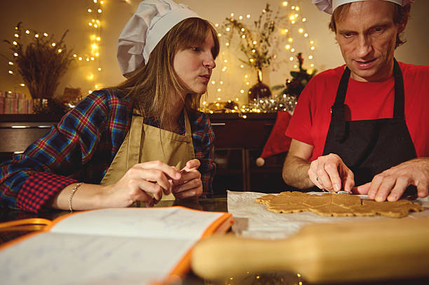 istock Two People in Chef Hats Craft Cookies in a Cozy Festive Kitchen 2240729096