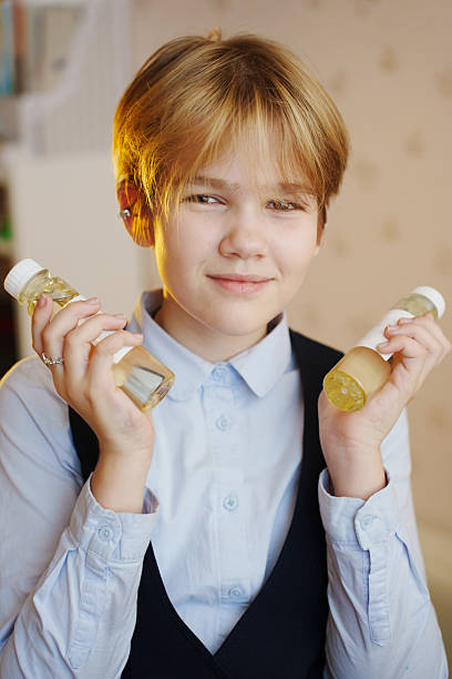istock Young person holding aroma diffuser liquids in a cozy indoor setting 2240730408