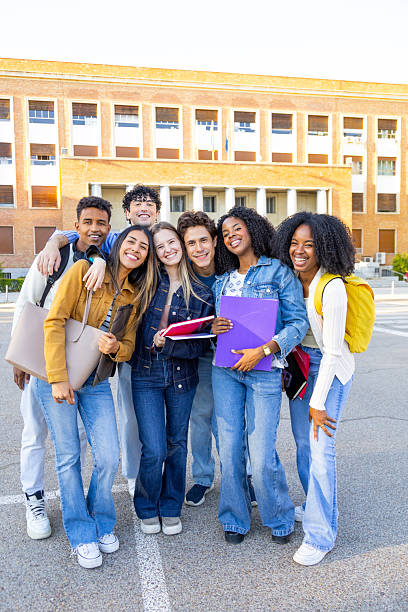istock Diverse students smiling outside university building portrait 2240730513