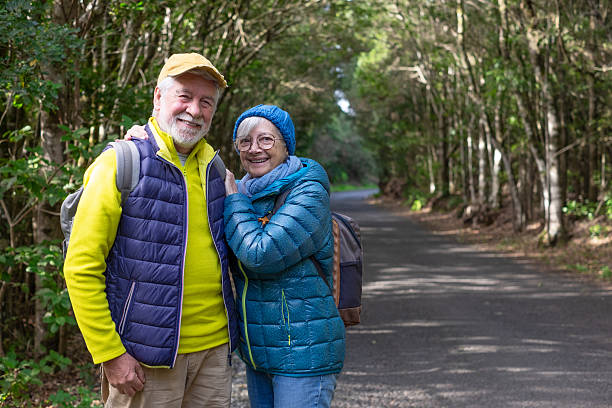 istock A cheerful senior couple hugging and looking at the camera while walking in a mountain forest, enjoying a healthy lifestyle in the fresh air. A cheerful senior couple with backpacks on a free day of vacation. 2240734099