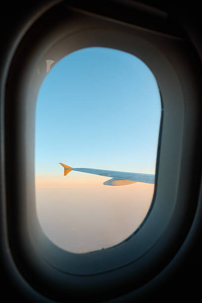 istock Flying high above the clouds during a stunning sunset journey 2240737071